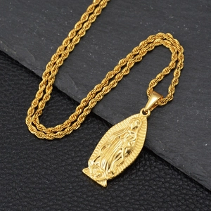 Hip hop gold Virgin Mary pendant necklace with twisted rope chain on stone background