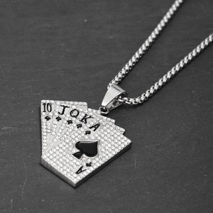 Macro shot of hip hop pendant with iced-out poker flush design on dark rock background