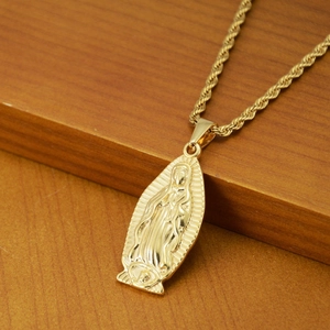 Golden Virgin of Guadalupe relief pendant necklace with rope chain on wooden stand