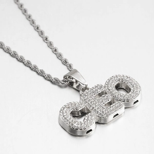 Macro shot of hip hop CEO letter pendant with iced out rhinestones on silver rope chain