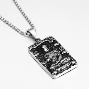 Macro detail of antique relief Buddha pendant made of durable brushed stainless steel