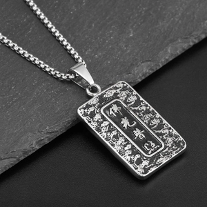 Macro shot of the Buddha pendant necklace with vintage relief engraving and Chinese characters