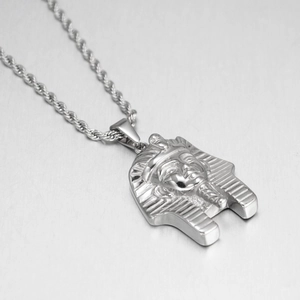 Macro detail of Egyptian Pharaoh mask pendant on thick twisted rope chain necklace