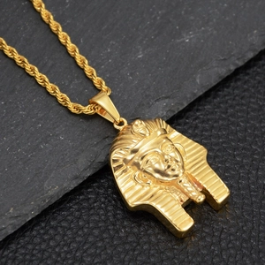 Detailed close-up of golden Egyptian pharaoh Tutankhamun pendant on twisted rope chain