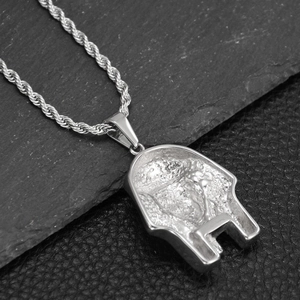 Macro shot of silver hip-hop necklace showing the detailed twist chain and mask pendant