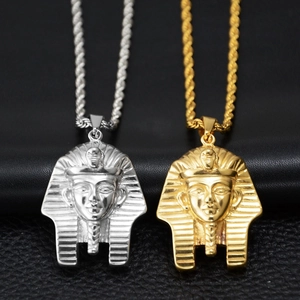 Detail view of gold and silver Egyptian Pharaoh pendants with twisted rope chains