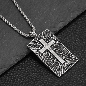 Detail shot of the vintage gothic cross pendant necklace with a textured steel finish