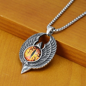 Close-up of gothic eagle wing pendant with mystic devil eye and stainless steel chain