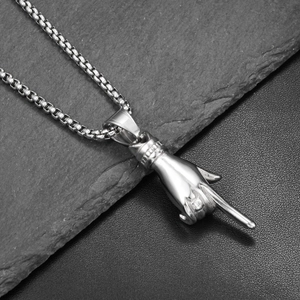 Detailed macro view of silver titanium steel hand gesture pendant with cubic zirconia inlay