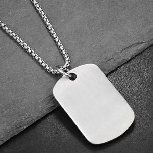Macro shot of brushed stainless steel military tag pendant on a durable box chain