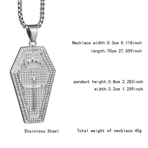 Close-up of silver coffin pendant with cross, crown detail and white zircon inlay