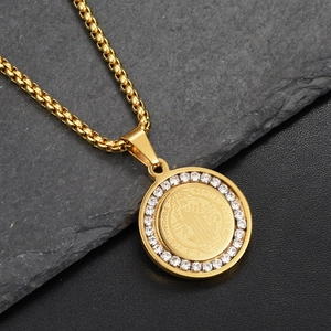 Detail of Saint Benedict medallion with sparkling zircon border on a gold box chain