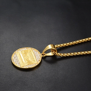 Detail of Last Supper gold pendant with cubic zirconia stones on black leather