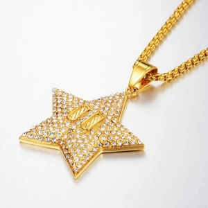 Detalle de colgante de estrella hip-hop con circonitas blancas y cadena box dorada