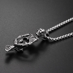 Gothic sitting skeleton pendant in vintage silver steel with a classic box chain