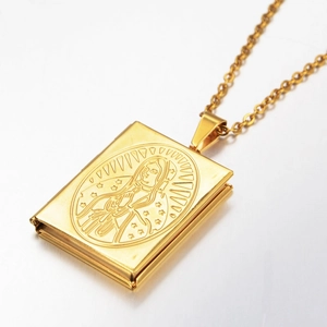 Macro shot of hinged gold book locket necklace featuring engraved Virgin Mary design