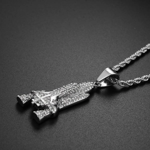 Macro shot of silver hip-hop rocket pendant with full crystal pavé on rope chain