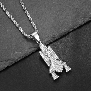 Macro shot of silver hip-hop space shuttle pendant with sparkling pave rhinestones