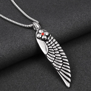 Hip hop titanium steel necklace with feather pendant and red stone on a gray background
