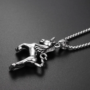 Detailed close-up showing the polished silver unicorn pendant with intricate textures