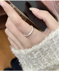 Detail of silver minimalist square texture stacking ring worn on index finger