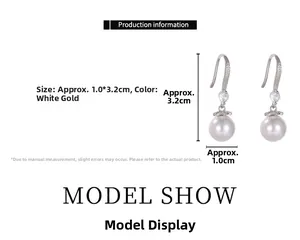 Detail view of pearl earrings with micro-set zircons measuring 1.0cm by 3.2cm