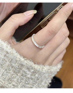 Detail of silver textured band ring worn on finger with minimalist retro aesthetic