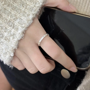 Silver square texture stackable ring with lava pattern shown on a hand holding a phone