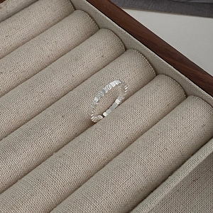 Elegant silver square texture lava ring with floral relief for minimalist stacked styling