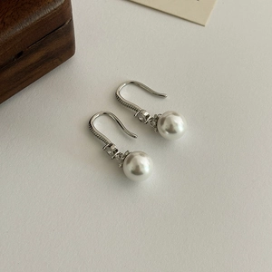 Elegant micro-paved pearl drop earrings for women with silver hooks on minimalist background