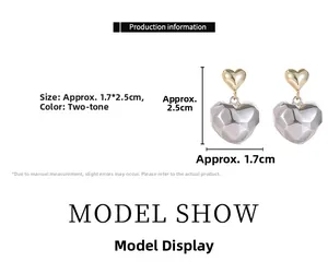 Vue détaillée des boucles d'oreilles cœur bicolores, dimensions 1,7 cm par 2,5 cm