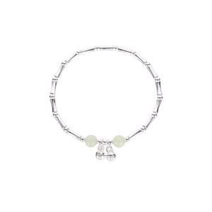 Bamboo style silver bracelet with pale green beads and tiny bells on white background