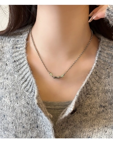 Hetian jade bamboo joint necklace with green beads on a silver chain worn by a model