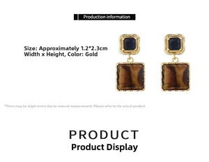 Detail of square tiger eye stone earrings with vintage gold textured metal frames
