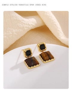 Detailed view of French vintage tiger eye stone square stud earrings on a white tray