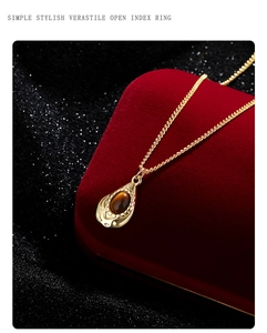 Tiger eye teardrop pendant necklace displayed on red velvet in a luxury jewelry box