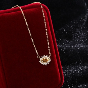 Evil eye necklace with tiger eye stone and crystals on red velvet box