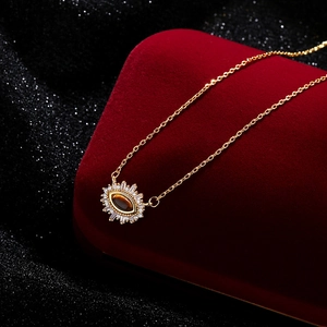 Maillard style gold tiger eye stone evil eye necklace with baguette zircon halo
