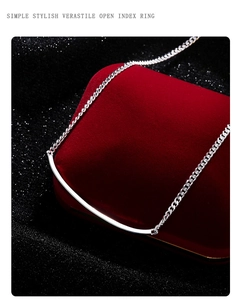 Minimalist silver smile pendant necklace displayed on a luxury red velvet jewelry box