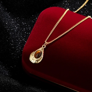 French vintage tiger eye teardrop necklace in gold plating on a luxury red velvet box