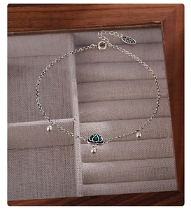 Detailed macro view of S925 silver anklet featuring a green lotus flower enamel pendant