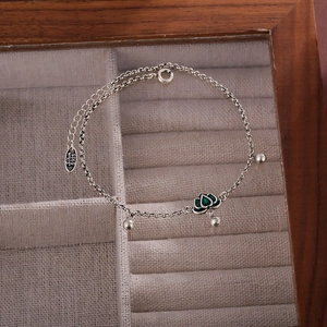 Silver S925 anklet with green lotus pendant and round beads in a wooden jewelry box