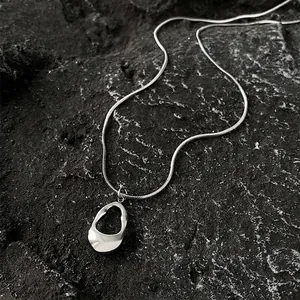 Minimalist silver irregular hollow oval pendant with sleek snake chain for women