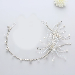 Elegant bridal silver hairband with sparkling crystals and white pearls for wedding dress