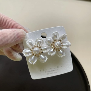 Elegant bridal floral earrings with white pearls, gold center, and 925 silver needle