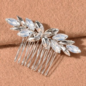 Macro detail of silver-tone bridal hair comb with marquise opals and sparkling crystals