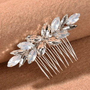 Macro shot of silver bridal hair comb with marquise-cut opal stones on brown velvet