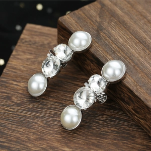 Elegant pair of silver tone drop earrings with lustrous pearls and sparkling crystal accents