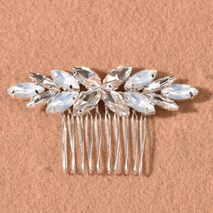 Detailed view of marquise rhinestones and opal stones on a silver bridal hair comb