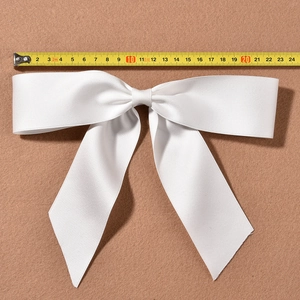 Large white satin bow hair clip for bridal styling measures approximately 22cm wide